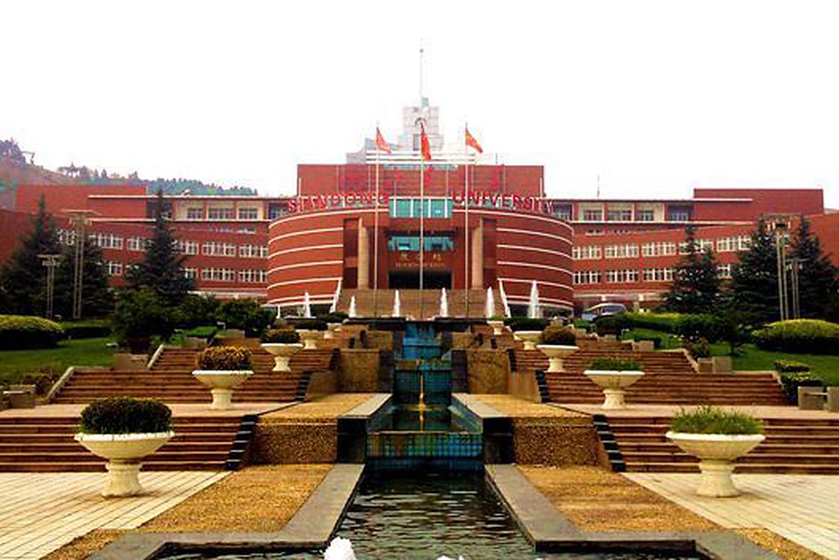 A brick editorial office building with landscaped grounds